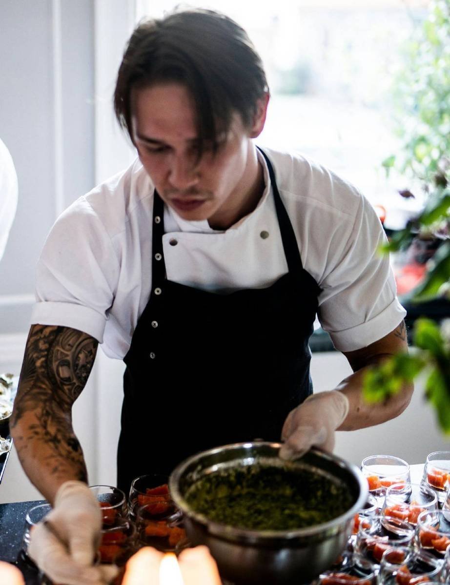 Sergio Morales Delgado, co-founder and head chef, plating a dish at Del Mar